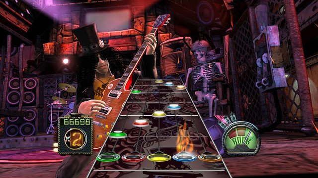 Slash on stage beside a five-color note highway in Guitar Hero III: Legends of Rock.