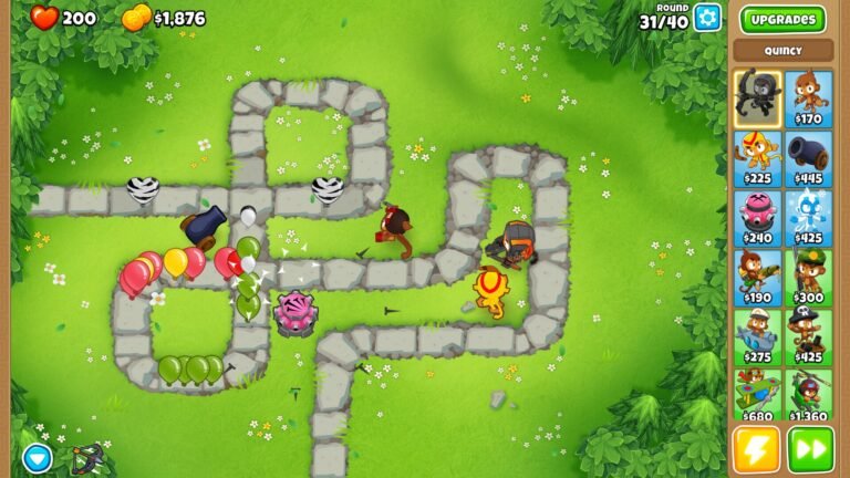 Macacos e outras defesas posicionados junto ao caminho enquanto Bloons coloridos avançam em Bloons TD 6.