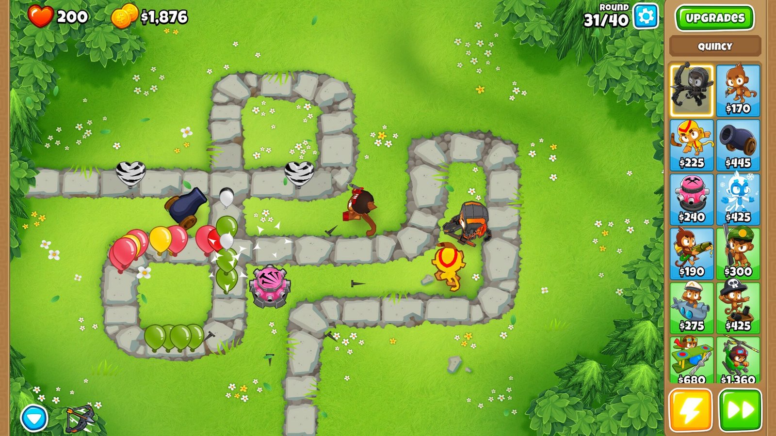 Monkeys and other defenses positioned along a path as colorful Bloons advance in Bloons TD 6.